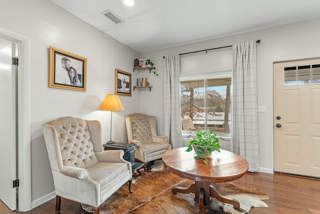 living area with hardwood / wood-style flooring