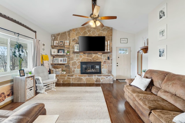 living room with ceiling fan, dark hardwood / wood-style flooring, lofted ceiling, and a fireplace