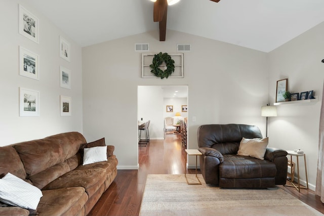 living room featuring vaulted ceiling with beams, ceiling fan, and dark wood-type flooring