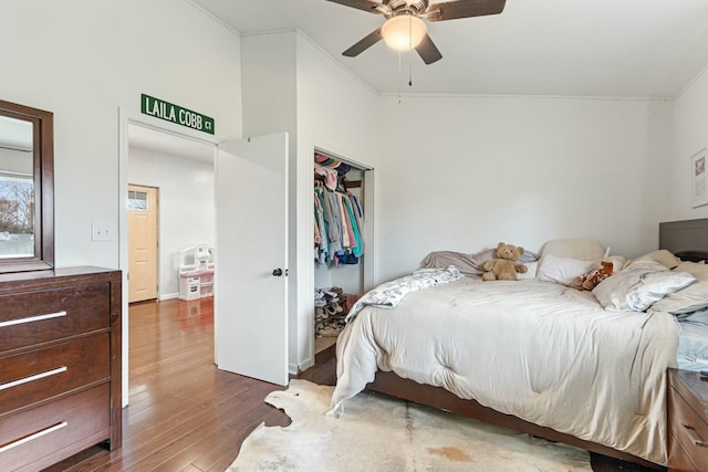 bedroom with hardwood / wood-style floors, a closet, ceiling fan, and lofted ceiling