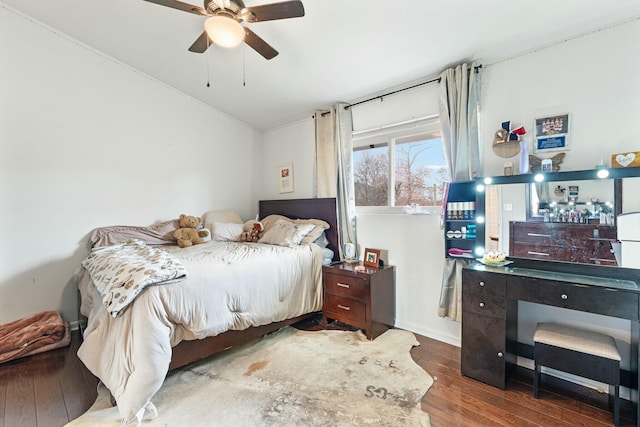 bedroom with ceiling fan, hardwood / wood-style floors, and vaulted ceiling