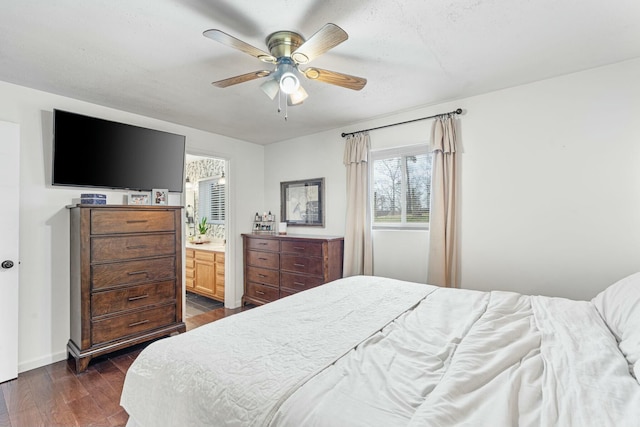 bedroom featuring a textured ceiling, dark hardwood / wood-style flooring, ensuite bath, and ceiling fan