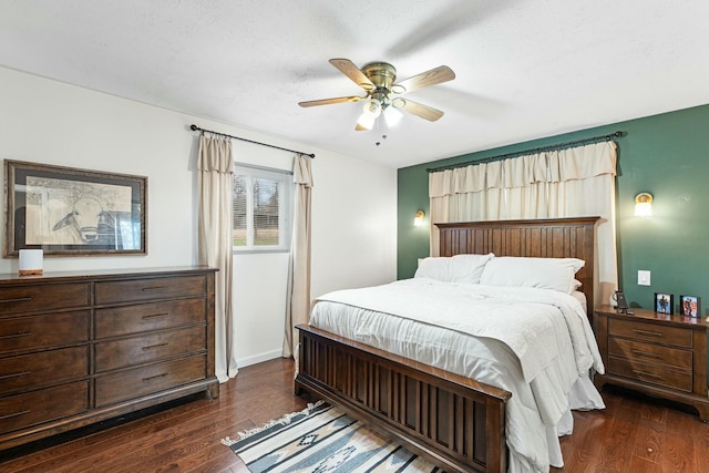 bedroom with a textured ceiling, dark hardwood / wood-style flooring, and ceiling fan