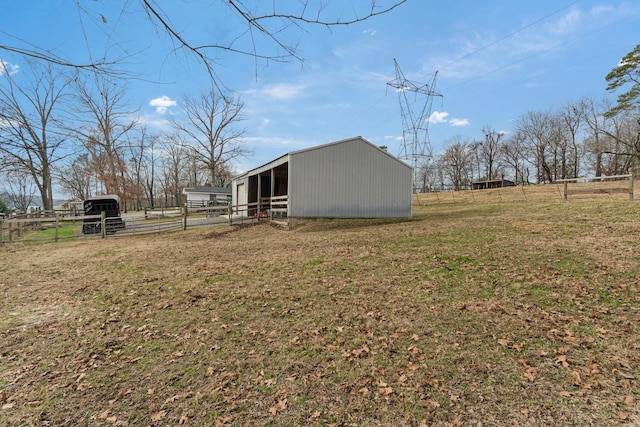 view of yard featuring an outbuilding and a rural view