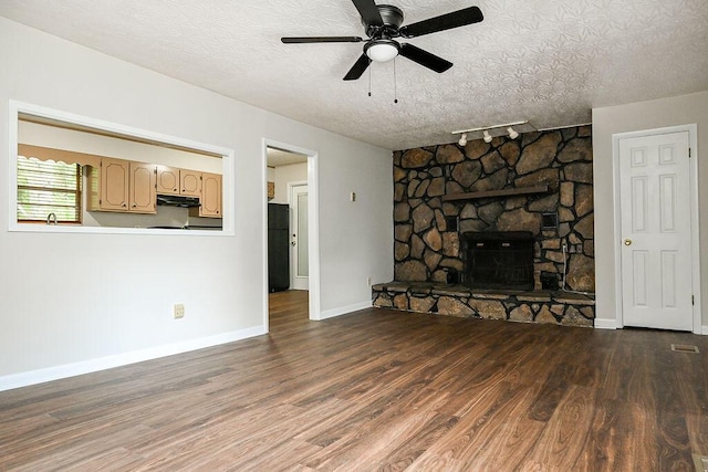 1132 Eldredge Cir NW, Cleveland, TN 37312 - unfurnished living room featuring track lighting, wood finished floors, a ceiling fan, baseboards, and a textured ceiling