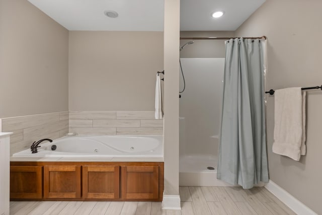 7083 Blue Springs Rd SE, Cleveland, TN 37311 - full bath featuring a jetted tub, a shower with curtain, and wood tiled floors