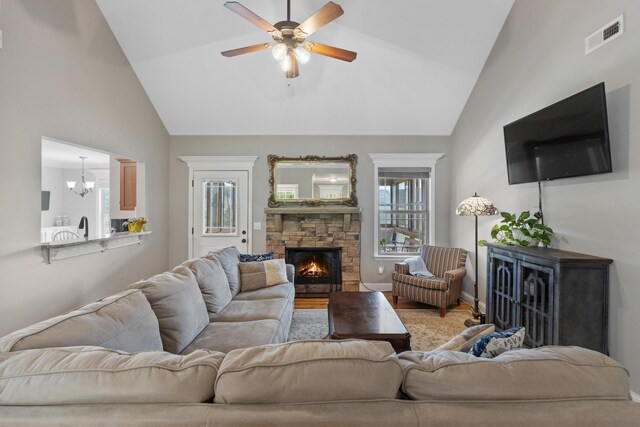 7083 Blue Springs Rd SE, Cleveland, TN 37311 - living area featuring a stone fireplace, ceiling fan, high vaulted ceiling, and light wood-style flooring