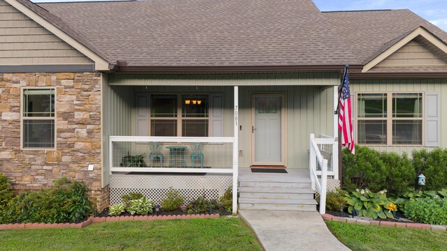 7083 Blue Springs Rd SE, Cleveland, TN 37311 - view of exterior entry with stone siding, roof with shingles, and covered porch