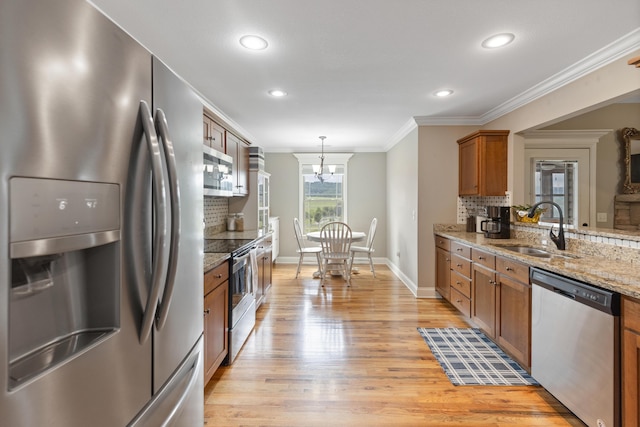 7083 Blue Springs Rd SE, Cleveland, TN 37311 - kitchen featuring appliances with stainless steel finishes, brown cabinetry, decorative backsplash, crown molding, and light wood finished floors