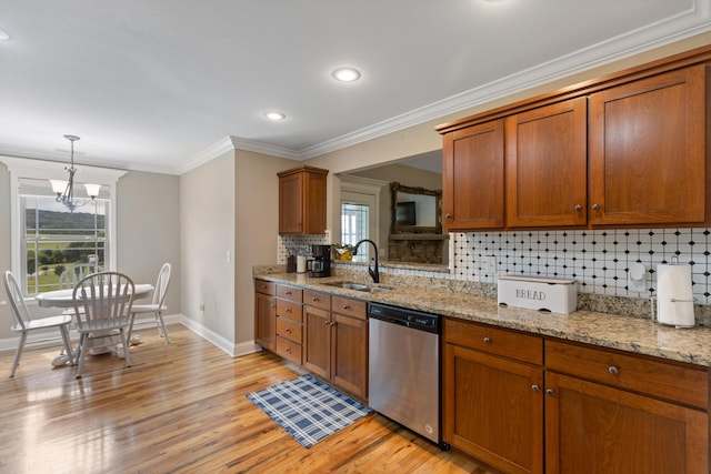 7083 Blue Springs Rd SE, Cleveland, TN 37311 - kitchen featuring stainless steel dishwasher, brown cabinets, ornamental molding, light wood finished floors, and tasteful backsplash