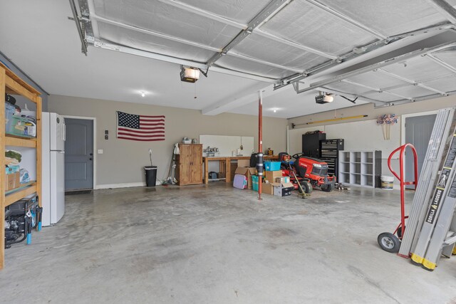7083 Blue Springs Rd SE, Cleveland, TN 37311 - garage featuring a garage door opener and freestanding refrigerator