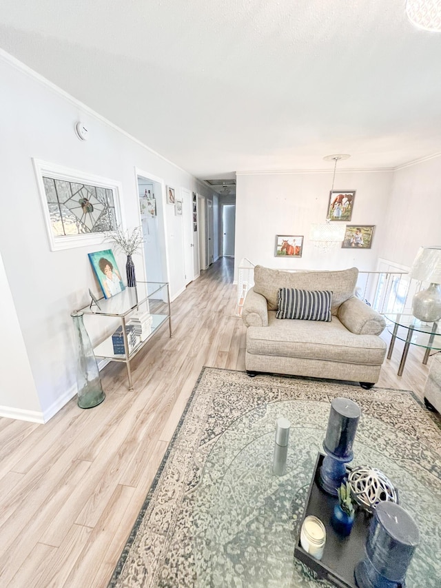 living room featuring baseboards, ornamental molding, and wood finished floors