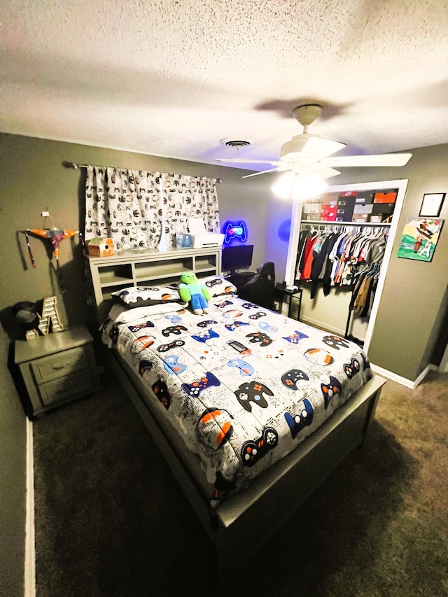 carpeted bedroom featuring a ceiling fan, a closet, a textured ceiling, and baseboards