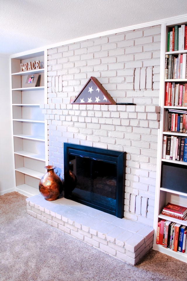 room details featuring a textured ceiling, a fireplace, and carpet flooring