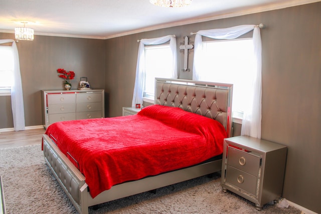 bedroom featuring baseboards, wood finished floors, and ornamental molding