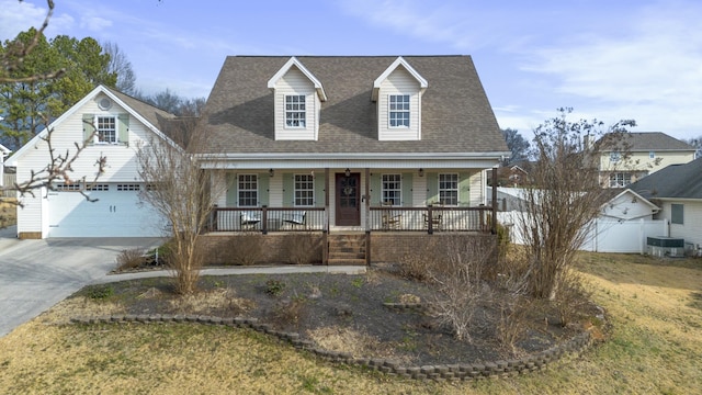 cape cod-style house featuring a garage, covered porch, and central AC