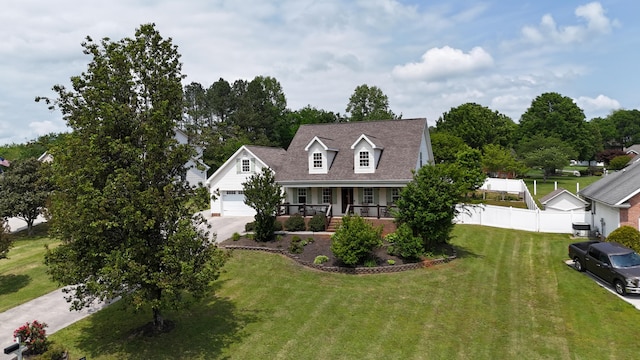 cape cod home with fence, covered porch, a front yard, an attached garage, and driveway