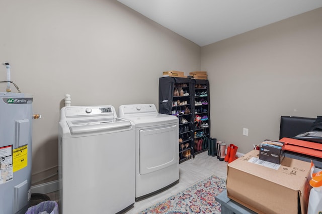 laundry room with separate washer and dryer and water heater