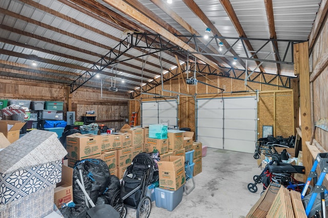 garage featuring a garage door opener and wooden walls