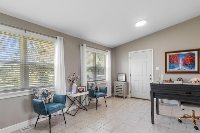 sitting room featuring vaulted ceiling