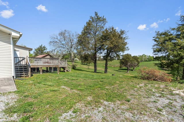 view of yard featuring a rural view and a wooden deck