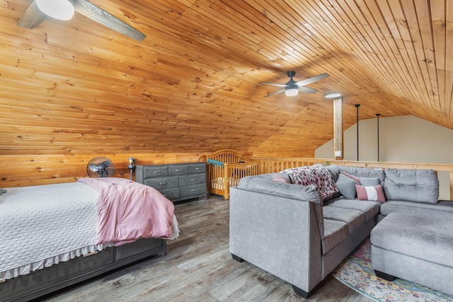 bedroom featuring hardwood / wood-style floors, ceiling fan, wood walls, and vaulted ceiling