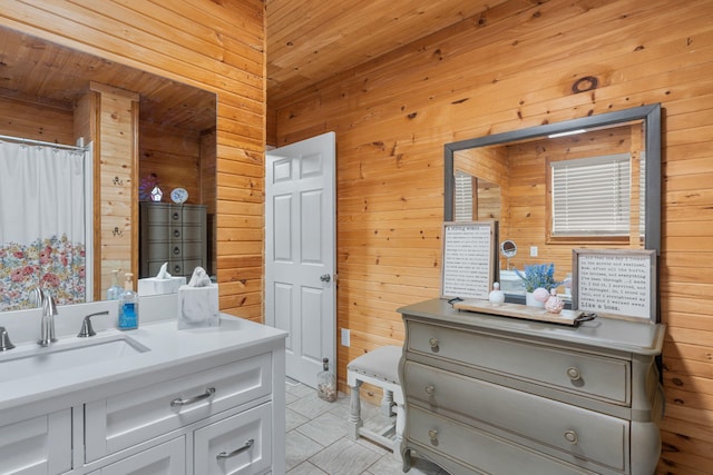 bathroom featuring a shower with curtain, vanity, tile patterned floors, and wooden walls