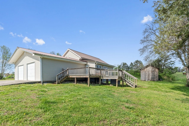 rear view of property featuring a storage unit, a lawn, and a wooden deck