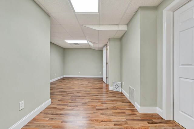 1454 Benjamin Cir NW, Cleveland, TN 37312 - below grade area with a drop ceiling, wood finished floors, and baseboards