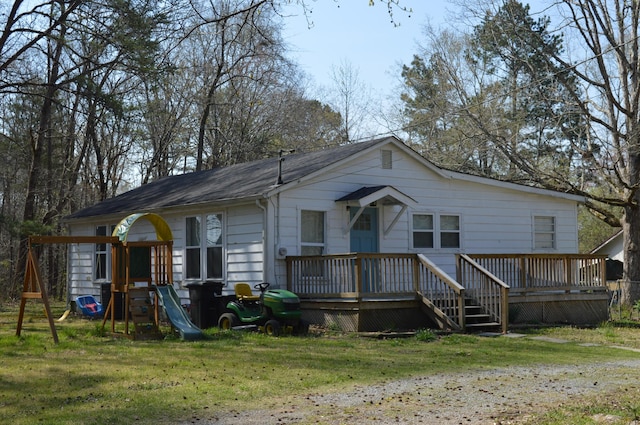 183 Bettis Ave SW, Cleveland, TN 37311 - view of front of house with a front lawn, a deck, and a playground