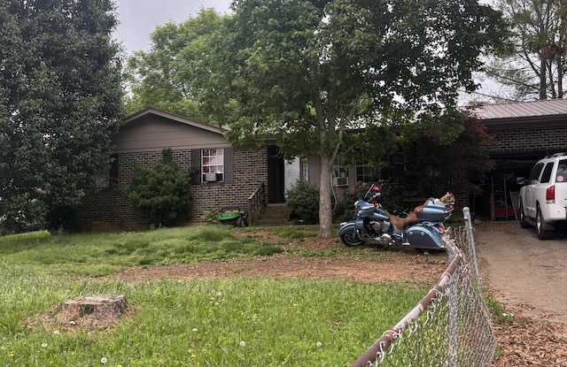 3715 Dockery St SE, Cleveland, TN 37311 - view of front of property featuring brick siding, fence, dirt driveway, and a carport