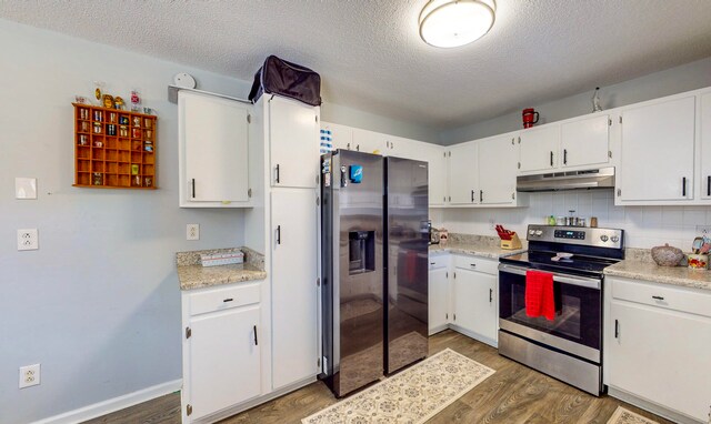 kitchen featuring appliances with stainless steel finishes, a textured ceiling, dark hardwood / wood-style floors, and white cabinetry