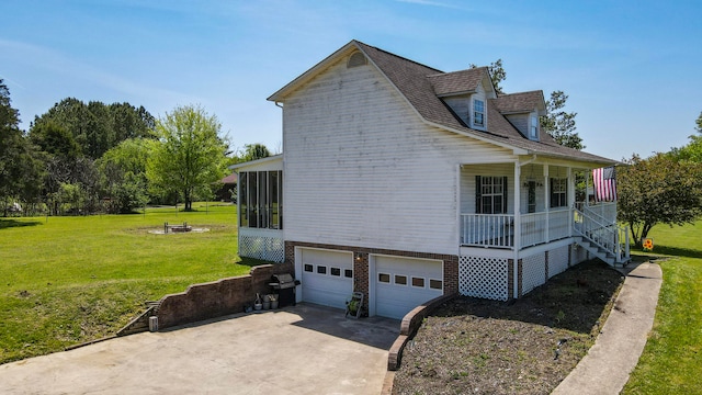 view of home's exterior featuring a lawn, a porch, and a garage