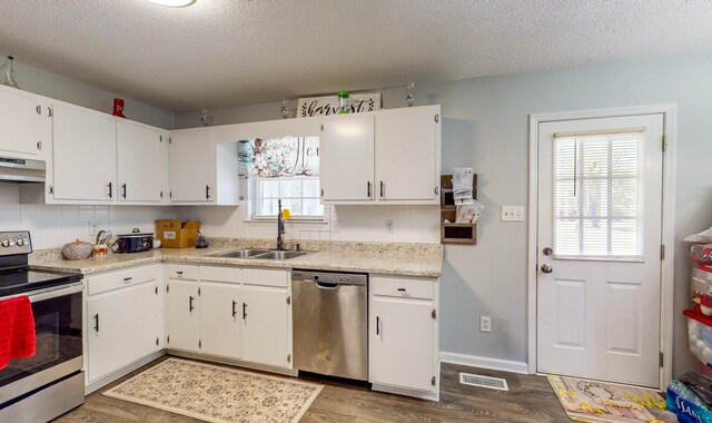 kitchen with white cabinetry, wood-type flooring, and appliances with stainless steel finishes