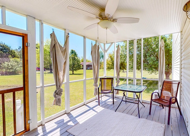 sunroom / solarium with a wealth of natural light and ceiling fan