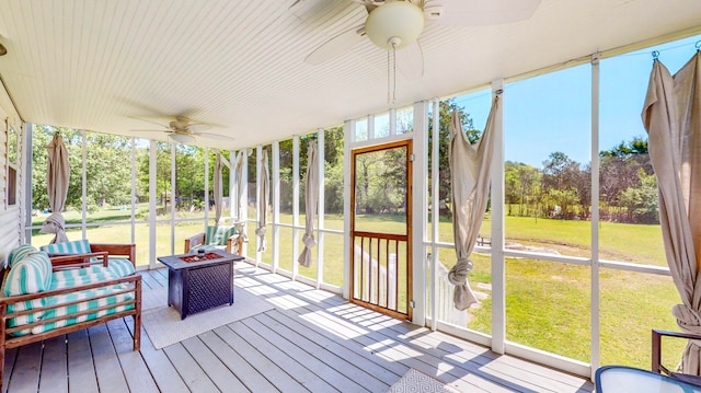 sunroom / solarium featuring ceiling fan