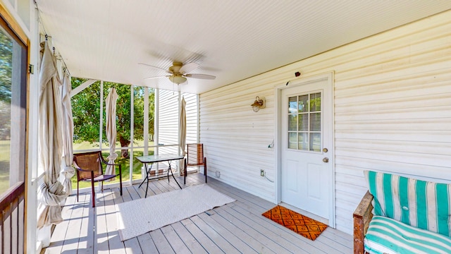 wooden terrace featuring ceiling fan and a porch