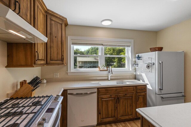 101 Riverview Ln, Reliance, TN 37369 - kitchen with white appliances, extractor fan, light countertops, and brown cabinetry