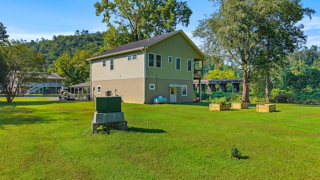 101 Riverview Ln, Reliance, TN 37369 - back of house featuring a lawn and stucco siding