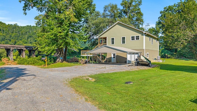 101 Riverview Ln, Reliance, TN 37369 - view of front of home with driveway, a front yard, stairs, and an attached carport