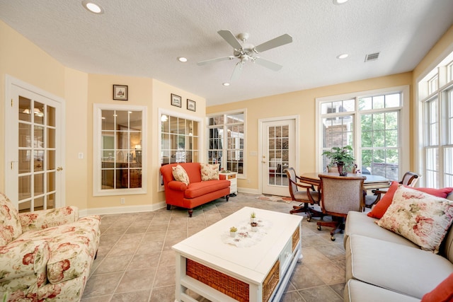 sunroom / solarium featuring ceiling fan