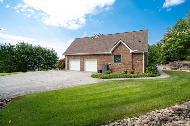 view of side of home featuring central AC unit and a yard