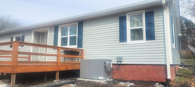 view of side of home featuring central AC and a deck