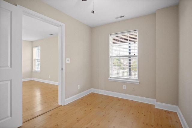 unfurnished room featuring light wood-style flooring and baseboards