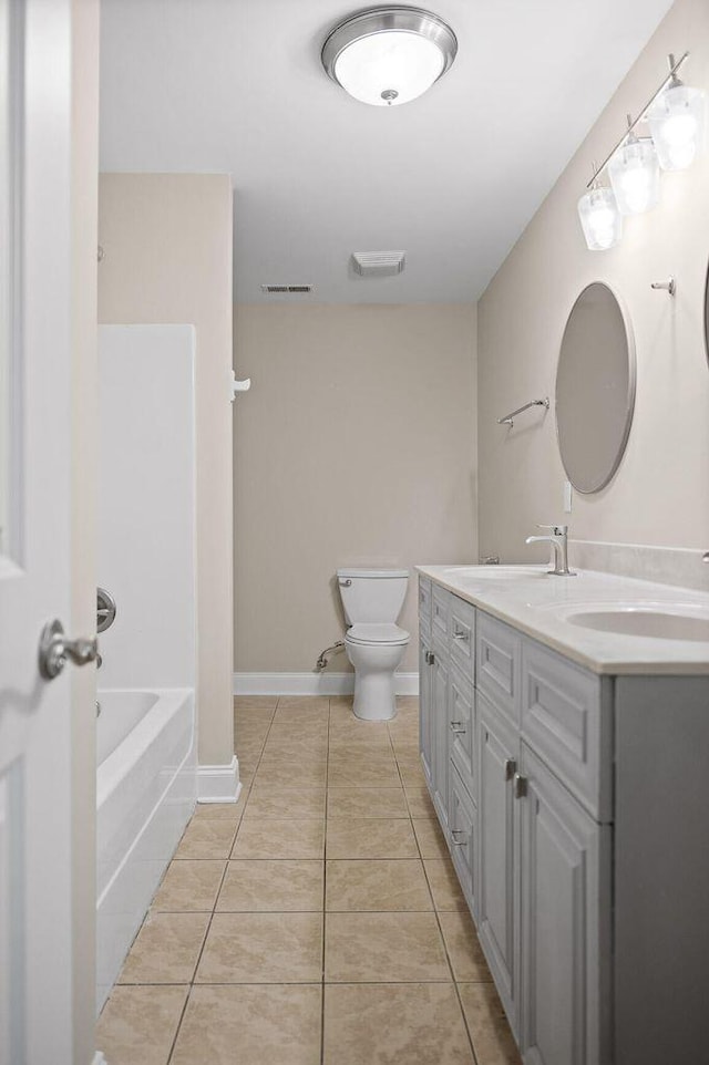 bathroom with toilet, a sink, tile patterned flooring, and visible vents