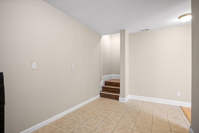 interior space featuring light tile patterned floors, baseboards, stairs, and visible vents