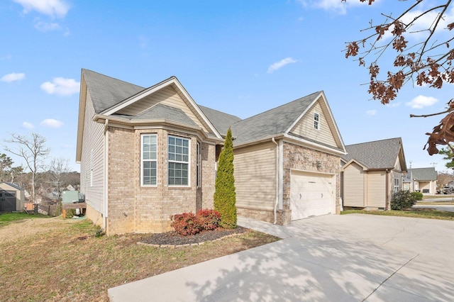 view of front facade featuring stone siding, concrete driveway, and brick siding