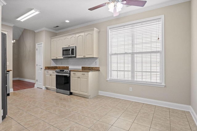 kitchen with crown molding, stainless steel appliances, backsplash, white cabinets, and light tile patterned flooring