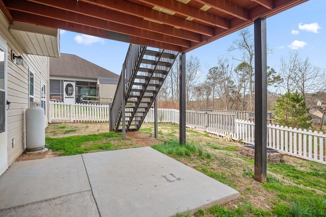 view of patio featuring a fenced backyard and stairway