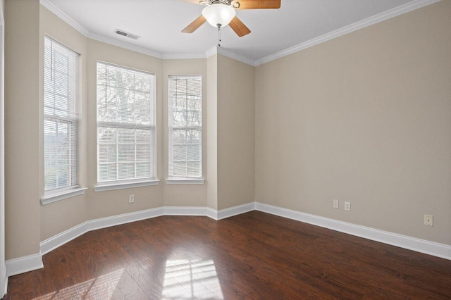 unfurnished room with dark wood-style floors, baseboards, visible vents, and a healthy amount of sunlight